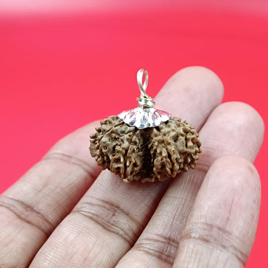 Brown textured pendant with a clear gemstone 