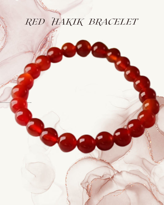 Red Hakik bracelet on a decorative background with floral elements