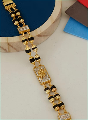Gold and black beaded necklace on a white background